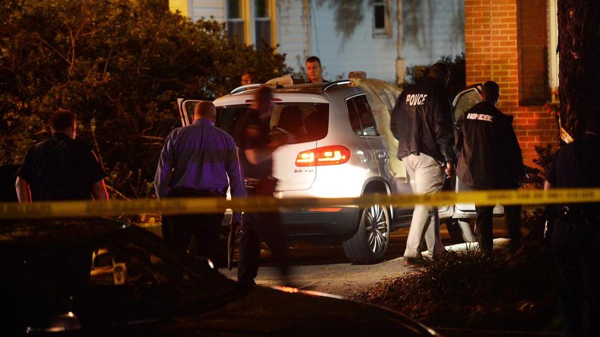 
Investigators at the scene where two people were shot to death on Oakland Avenue in Durham.
