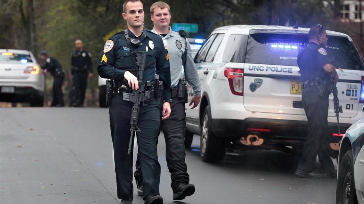 UNC-CH police officers stand down and return to their patrol cars after a second man-with-a-rifle call on Battle Lane adjacent to the UNC-CH campus. A man-with-a-gun call came in earlier Wednesday morning outside the UNC ROTC Armory building , which caused a lock down on the UNC campus. UNC cleared the call within an hour when the call turned out to be false. A second call about 11 a.m. about a man with a rifle shooting at a home on Battle Lane came in and officers found a homeowner shooting a BB gun at a squirrel.