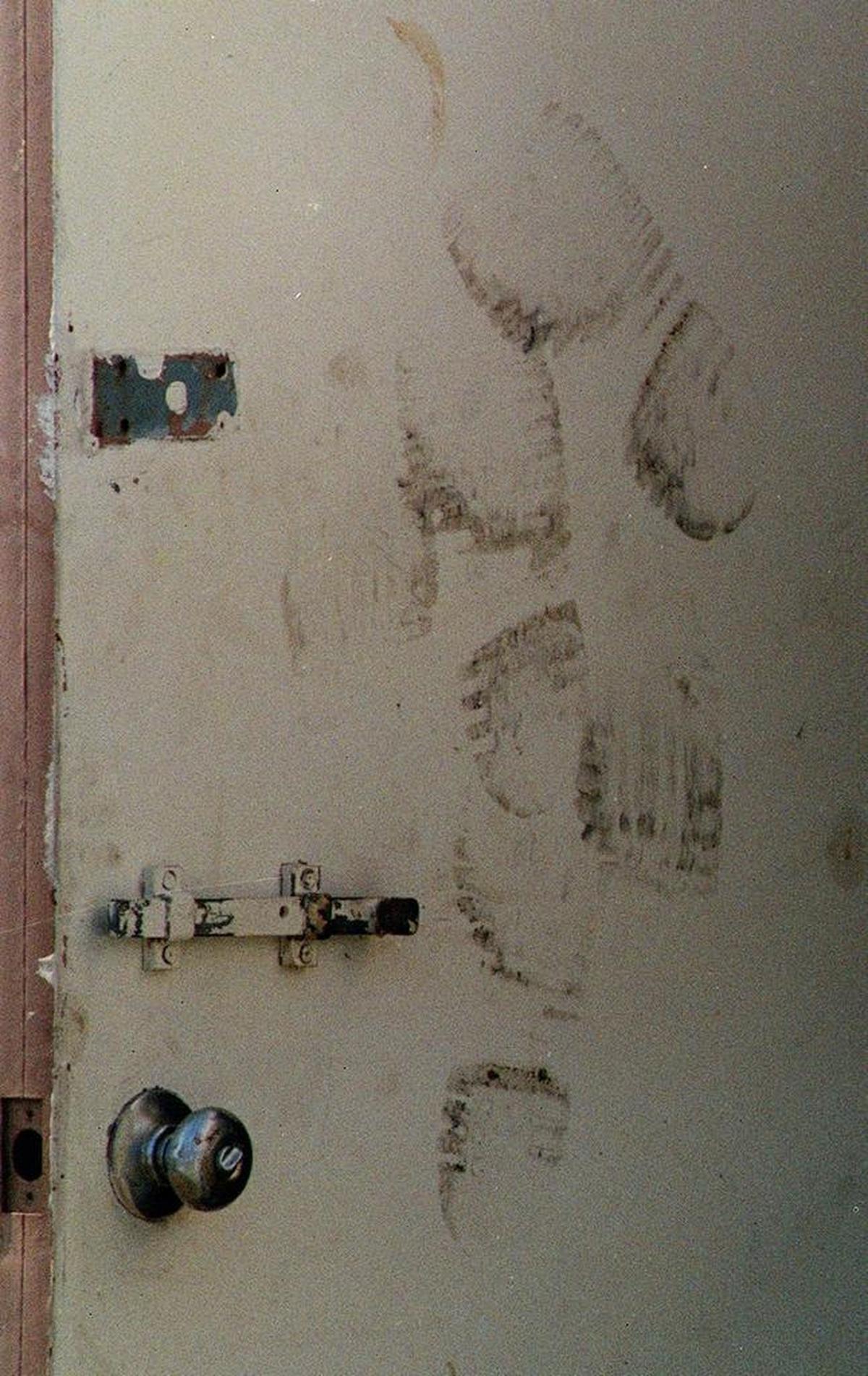 Blackened footprints mark the door to the employee lounge where workers tried to kick their way out to escape the fire at Imperial Food Products plant in Hamlet. Witnesses said the doors at the plant were locked, trapping workers inside. (JIM BOUNDS/Staff)