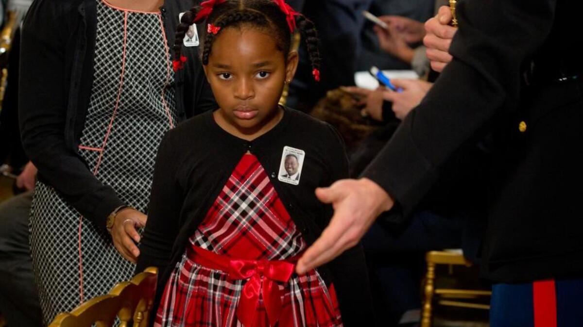 A U.S. Marine escorts Malana Pinckney, daughter of the late Rev. Clementa Pinckney, who was shot in a church in Charleston, S.C., last year, to her seat during an announcement by President Barack Obama on executive actions he will make intended to expand background checks for some firearm purchases and step up federal enforcement of the nation’s gun laws.