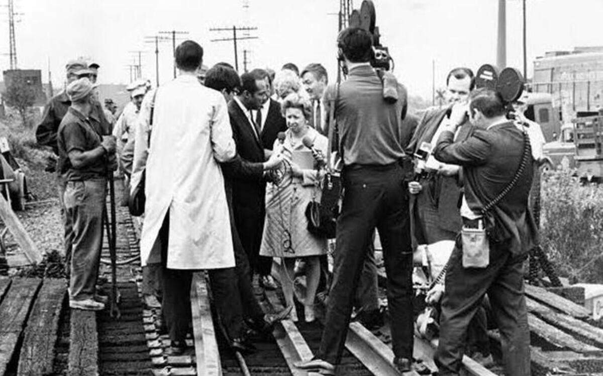 
Cleveland Mayor Carl Stokes talks to the media on a railroad trestle damaged when the Cuyahoga River caught fire in June 1969. 
