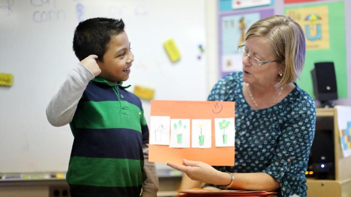 Oziel Vargas-Mendez reads a story to his pre-kindergarten class with the help of his teacher Jean Evans on March 28, 2014 at Hilburn Academy in Raleigh.