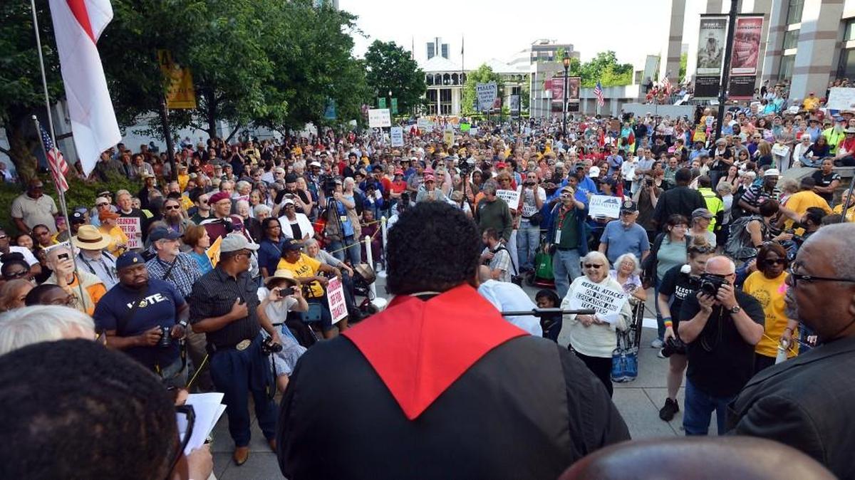 The Rev. William Barber II speaks to hundreds of supporters during the first Moral Monday protest of the 2014 Short Session of the General Assembly in 2014. He and Jonathan Wilson-Hartgrove say: “Moral Mondays became the largest state-based civil disobedience campaign in U.S. history because fusion friendships like ours refused to give in to extremists’ assault.”