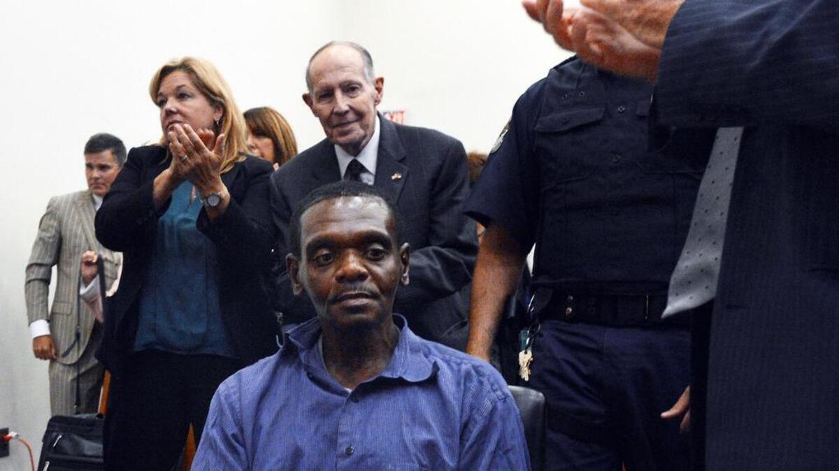 Behind Henry McCollum, sitting stunned after a judge declared him and his brother Leon Brown innocent after they spent 30 years in prison, is I. Beverly Lake Jr., founder of the Innocence Commission.