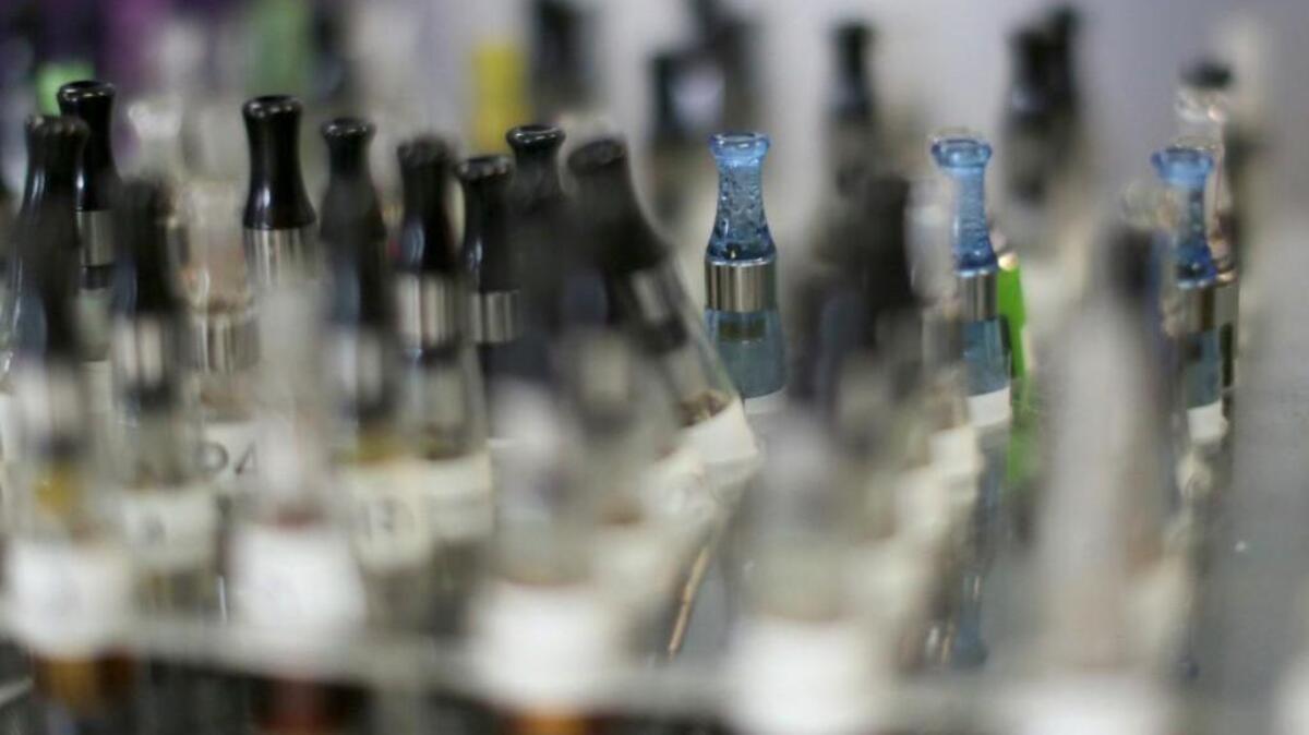 Electronic cigarette liquid tanks sit on the counter an electronic cigarette store, Friday January 31, 2014 in Cary, N.C.