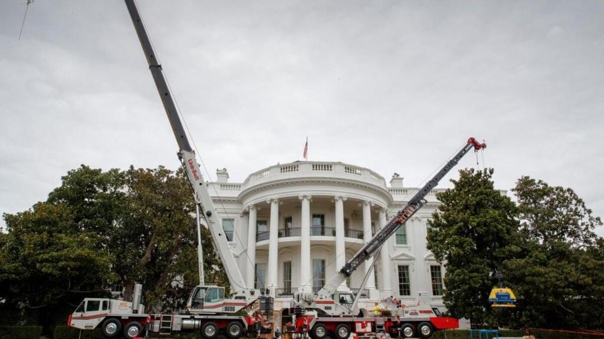FILE - In this Aug. 11, 2017 file photo, cranes are positioned in front of the South Portico of the White House in Washington during renovations. The White House is visibly under renovation during President Donald Trump’s one-day return to Washington.