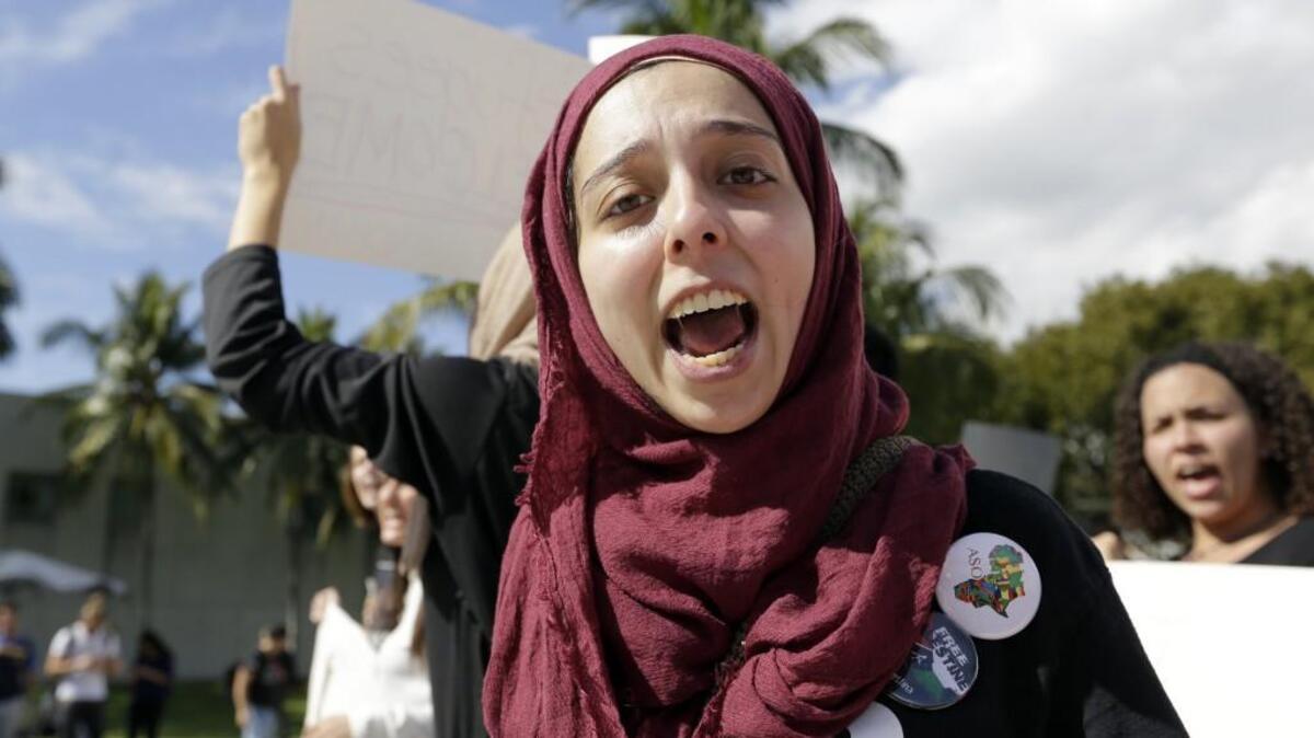 Victoria Rivera, 22, shouts slogans during a protest at Florida International University against President Donald Trump's executive order to ban travelers and immigrants from seven predominantly Muslim countries, Wednesday, Feb. 1, 2017, in Miami.