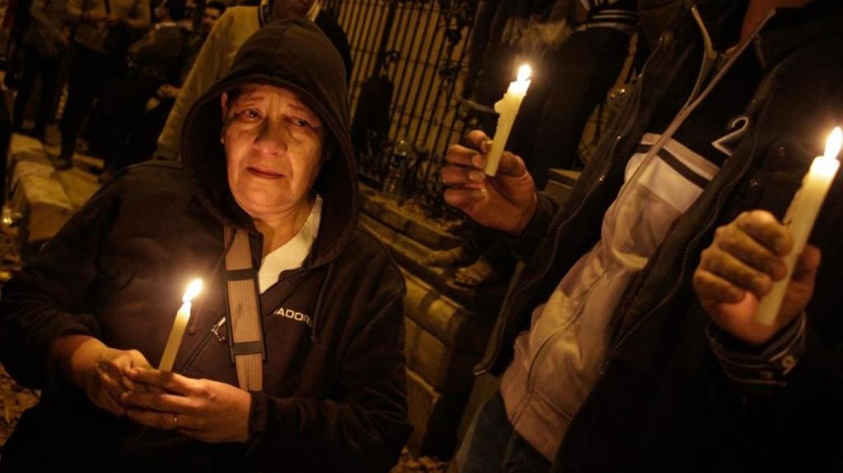 Egyptians carry candles during a vigil for the victims of a bomb explosion that targeted the Saint Peter and Saint Paul Coptic Orthodox Church on Dec. 11, 2016outside the Church in Cairo.