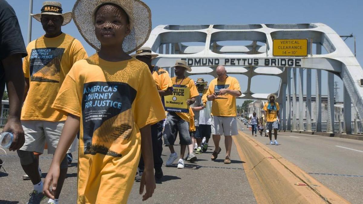 
Velivia Peterson, 8, walks with others across the Edmund Pettus Bridge during the start of ‘America’s Journey for Justice March’ organized by the NAACP.
