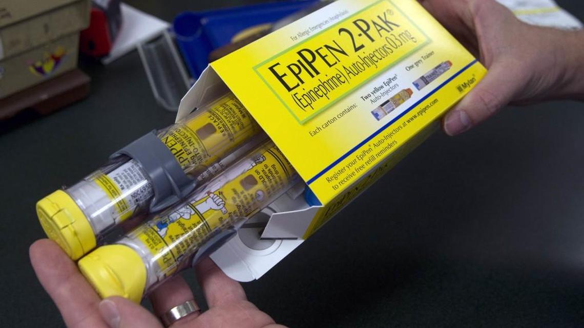 A pharmacist holds a package of EpiPens epinephrine auto-injector, a Mylan product