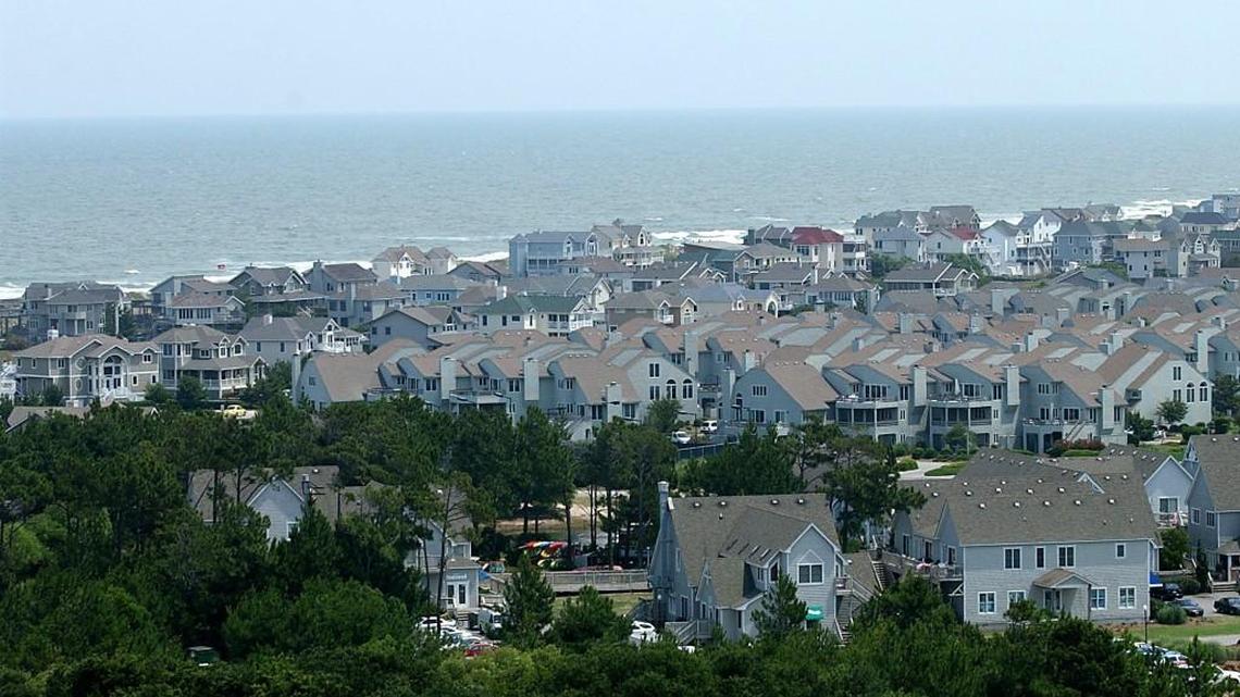 Rows of houses near the Currituck Beach Lighthouse, along the Atlantic coast in Corolla, on the Outer Banks of North Carolina.