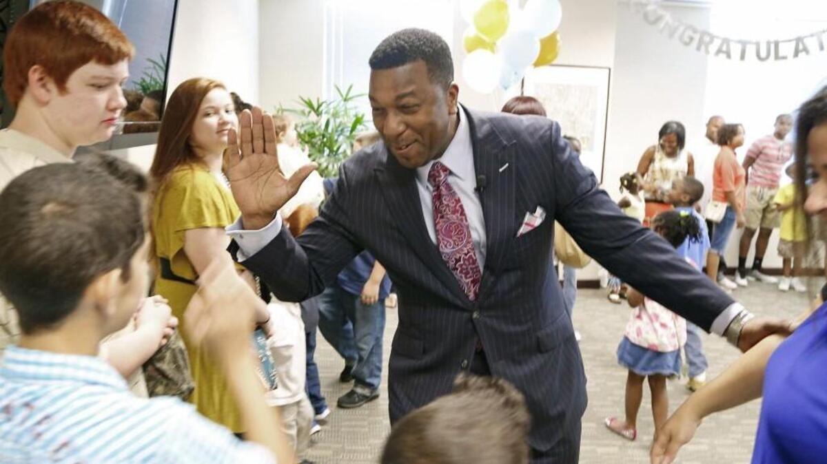 
Darrell Allison, center, president of Parents for Educational Freedom in North Carolina, greets families and supporters as they celebrate the news that they will be able to stay in private schools now that the N.C. Supreme Court has ruled that vouchers are constitutional. 
