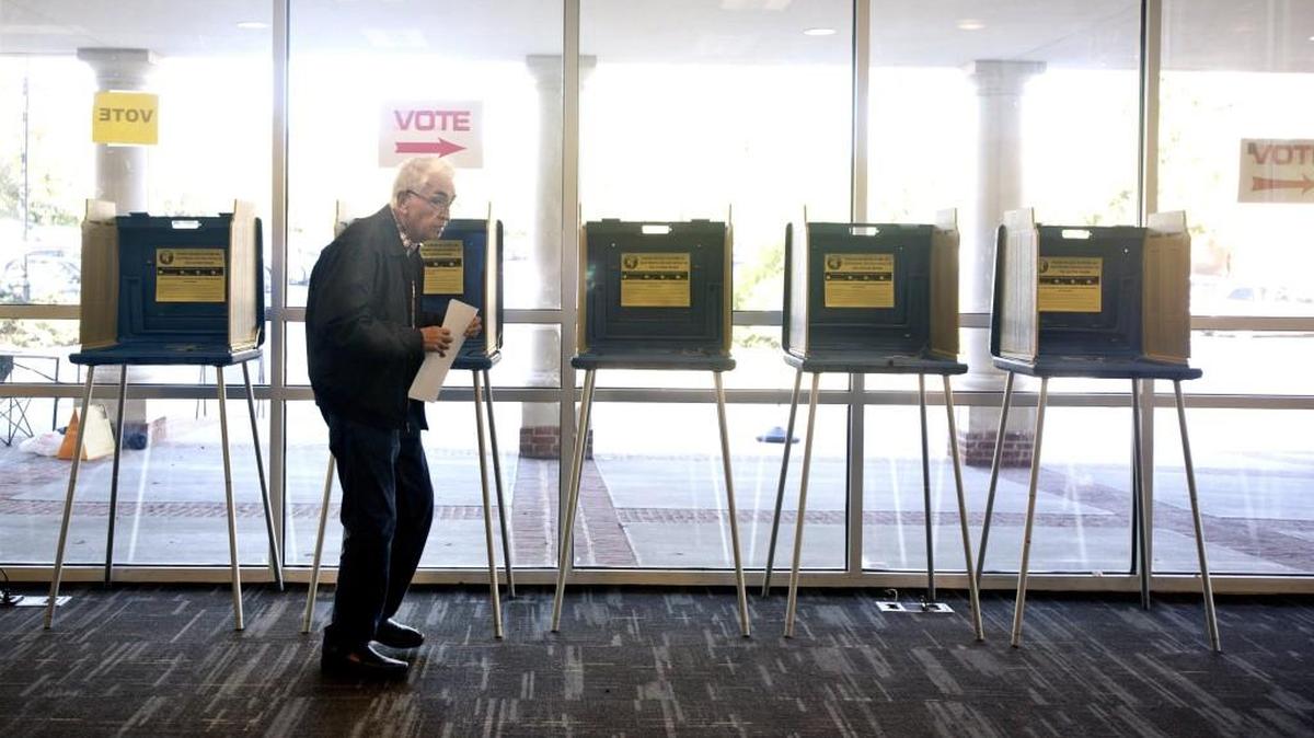 Taking a break as a precinct volunteer at Cary Academy, Raymond Woody, 81, casts his vote on Tuesday, Oct. 6, 2015 for local, municipal elections.
