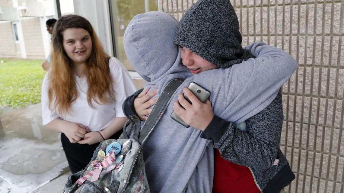 East Wake High School valedictorian Megan Faircloth, right, gets a congratulatory hug from a classmate at the end of the school day on June 5, 2017. Megan's sister Jacey Faircloth looks on at left. Megan spoke at a recent awards ceremony about being homeless during her junior year. She persevered through the adversity to achieve the highest class rank and received a near full scholarship to Stanford Univ.