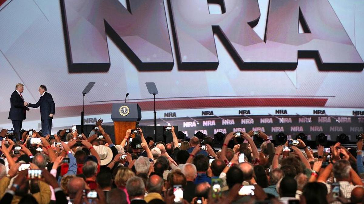 President Donald Trump, left, shakes hands with National Rifle Association Executive Vice President Wayne LaPierre as he arrives for the National Rifle Association Leadership Forum, Friday, April 28, 2017, in Atlanta.