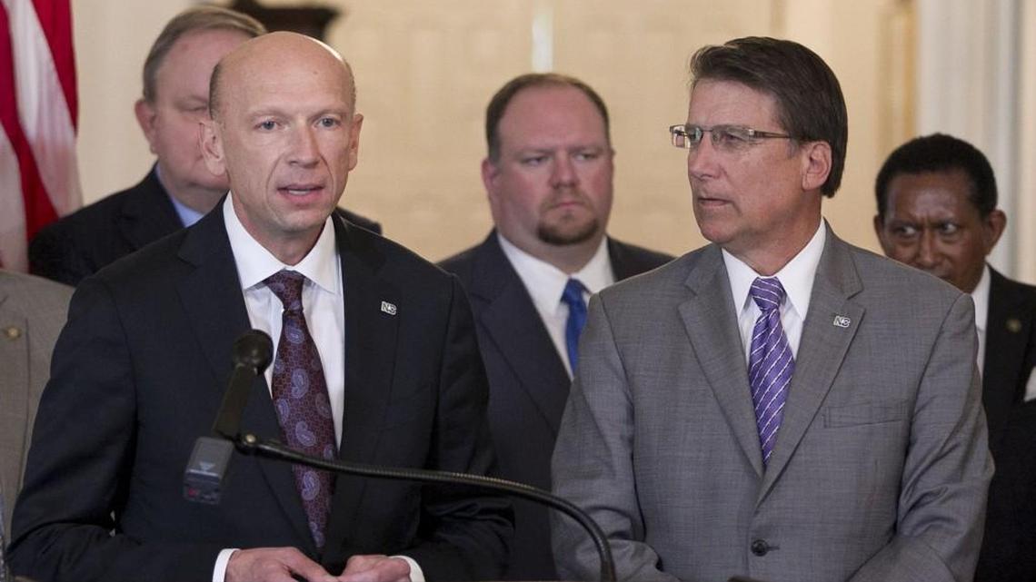Gov. Pat McCrory listens to Secretary of Health and Human Service Rick Brajer, left, prior to signing Medicaid privatization legislation at the Executive Mansion in September.