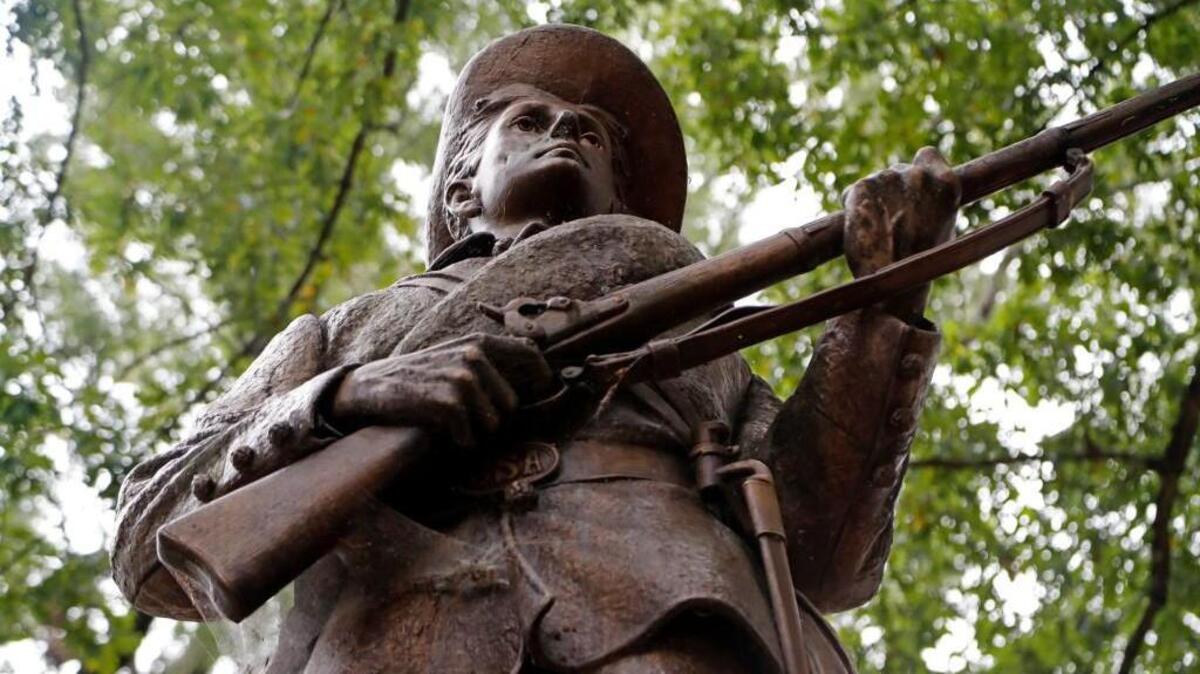 UNC holds its annual University Day ceremony at Memorial Hall on the campus in Chapel Hill, NC, on Oct. 12, 2017. Several dozen protesters held small signs demanding that the statue of a Confederate soldier known as Silent Sam, seen here, be taken down.