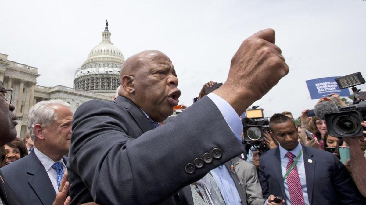 Rep. John Lewis, D-Ga., center, and other Democrats stream onto the steps of the East Front of the Capitol after ending a 25-hour protest over gun control legislation Thursday in Washington.