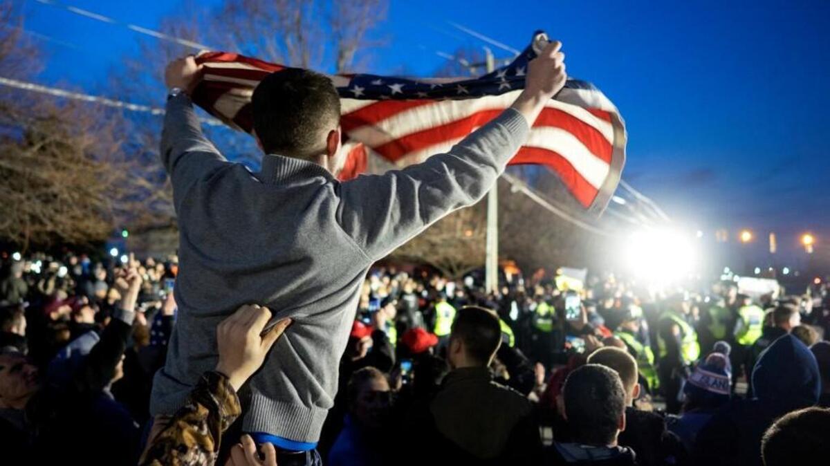 In this Wednesday, April 6, 2016 file photo, a Donald Trump supporter waves a U.S. flag as he and others face off with anti-Trump protesters about 50 feet away, near the site of a campaign appearance by the then-Republican presidential candidate in Bethpage, N.Y.