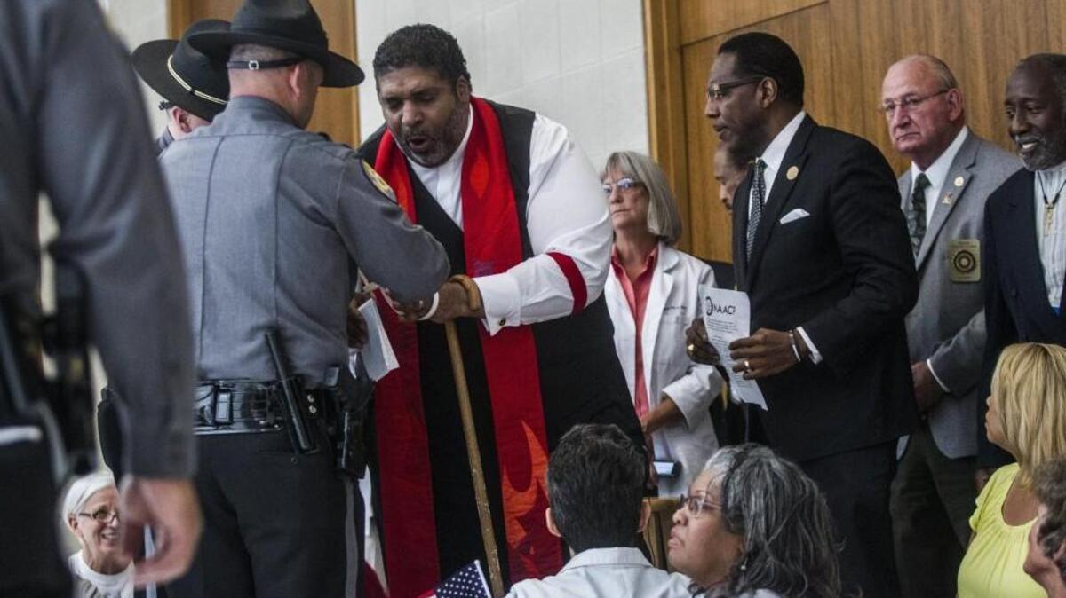 The Rev. William Barber, president of the state chapter of the NAACP, being arrested Tuesday at the state Legislative Building in Raleigh during a protest of the legislature’s refusal to expand Medicaid.
