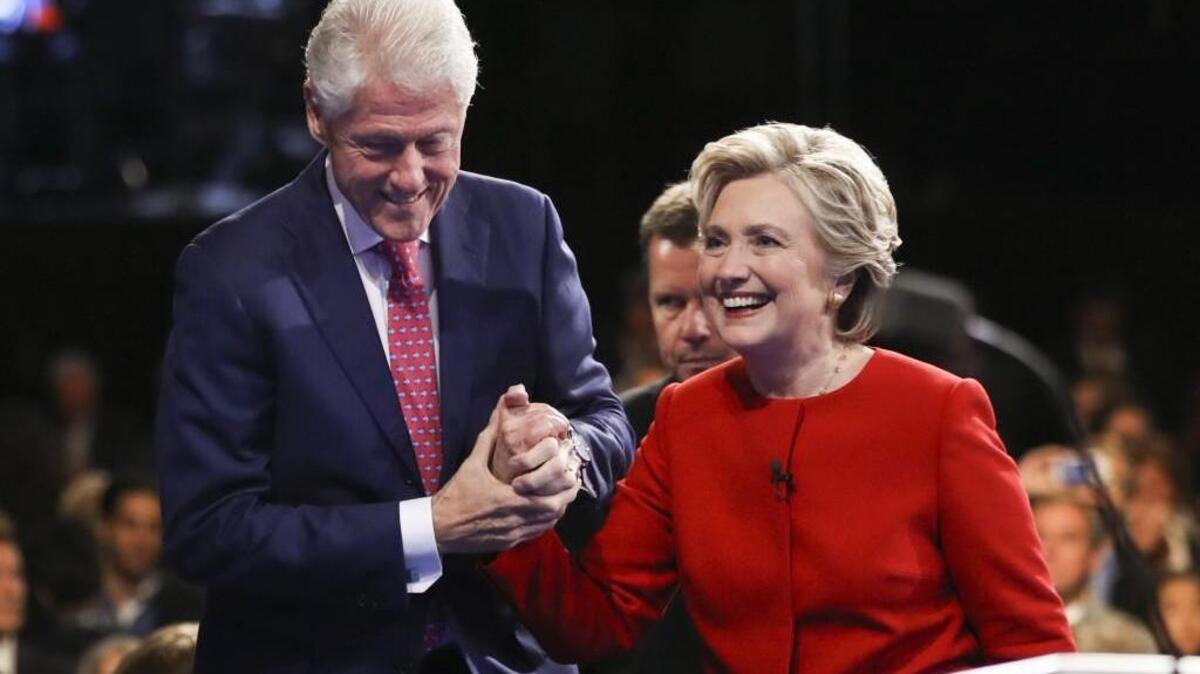 Democratic presidential nominee Hillary Clinton walks off the stage with her husband former President Bill Clinton after the first presidential debate with Republican presidential nominee Donald Trump at Hofstra University in Hempstead, N.Y.,
