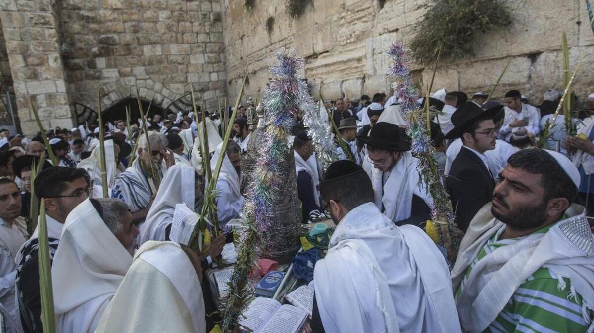 Ultra-orthodox Jewish men covered in prayer shawls prior to the Cohanim Priestly caste blessing pray during the holiday of Sukkot, in front of the Western Wall, the holiest site where Jews can pray in Jerusalem's Old City, Wednesday.