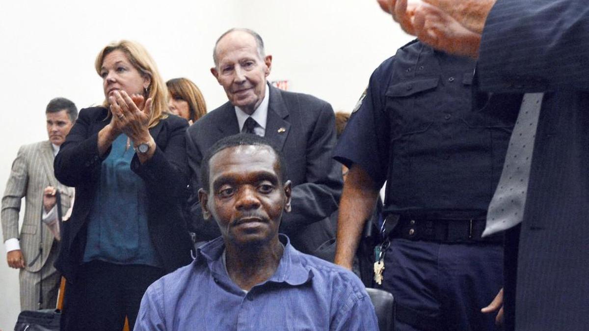 Henry McCollum sits as applause rings out in a Robeson County courtroom after a judge declares him and his brother Leon Brown innocent of a brutal rape murder for which they spent 30 years in prison. Behind him is I. Beverly Lake Jr., founder of the Innocence Commission.