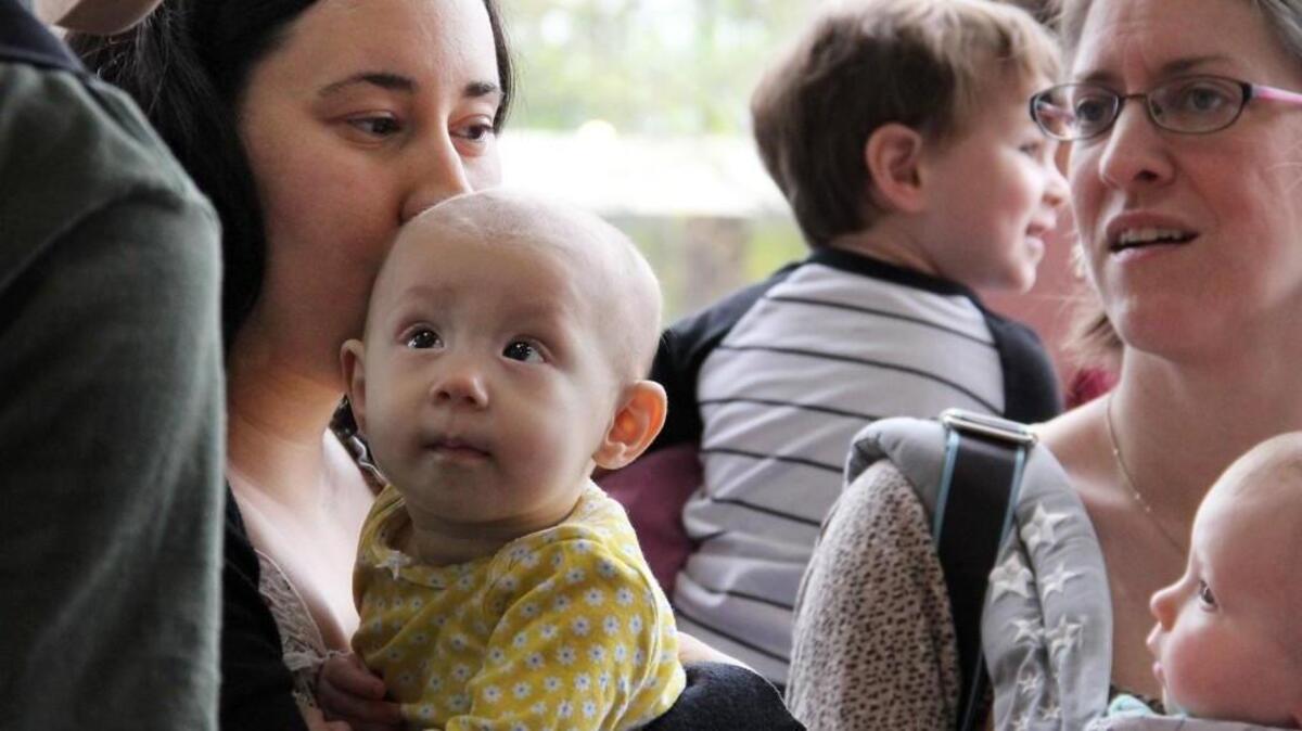 Yael Symes holds her 7-month-old daughter Evelyn during a “nurse-in” on April 2 at the Durham Costco.