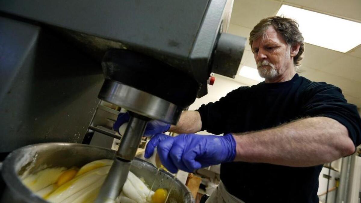 In this March 10, 2014 file photo, Masterpiece Cakeshop owner Jack Phillips cracks eggs into a cake batter mixer inside his store in Lakewood, Colo.