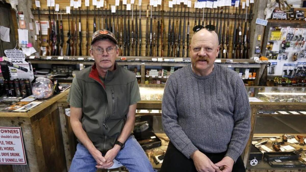 In this Feb. 23, 2016 photo, Police Commander Keith Caddy, right, sits with Gun Depot shop manager Bobby Gray in Montrose Colo, where suicide rates are among the highest in the nation. Caddy is doing outreach for the Gun Shop Project, and most of the businesses he has visited agreed to display the suicide-awareness materials once they were assured it wasn’t a gun-takeaway program in disguise.