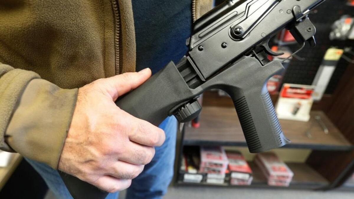 SALT LAKE CITY, UT - OCTOBER 5: A bump stock device that fits on a semi-automatic rifle to increase the firing speed, making it similar to a fully automatic rifle, is installed on a AK-47 semi-automatic rifle, (right) at a gun store on October 5, 2017 in Salt Lake City, Utah. Congress is talking about banning this device after it was reported to of been used in the Las Vegas shootings on October 1, 2017.