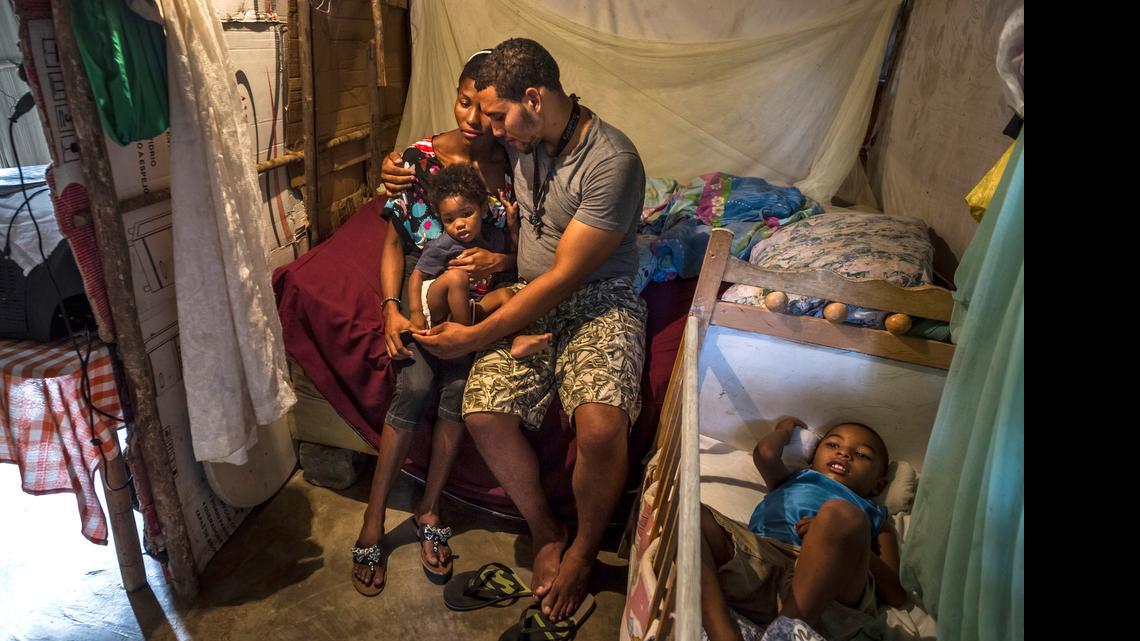 A couple identified only as Roberto and Yoseline with their children at their home in Sabaneta, Dominican Republic. Yoseline has been unable to prove citizenship.