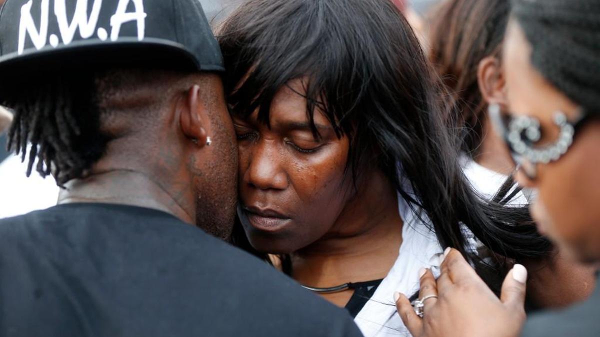 Sandra Sterling, aunt of Alton Sterling, is comforted at a vigil outside the Triple S convenience store in Baton Rouge, La. Sterling, 37, was shot and killed outside the store by Baton Rouge police, where he was selling CDs.