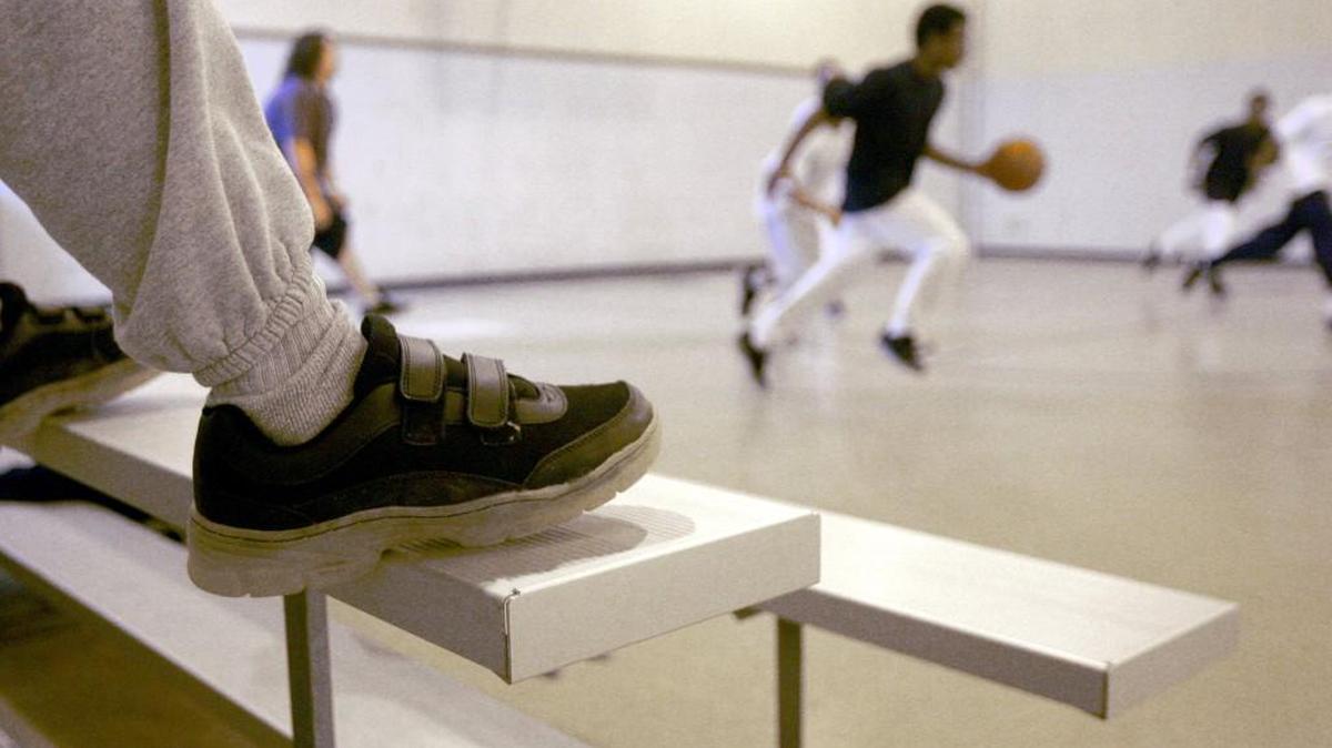Boys play basketball at the Polk Youth Institution juvenile detention facility in Butner.
