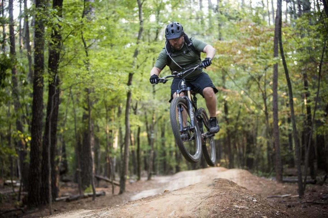 A man rides the popular mountain bike trails on RDU Airport Authority’e FATS tract leased by the Lake Crabtree County Park Wednesday, October 8, 2014.