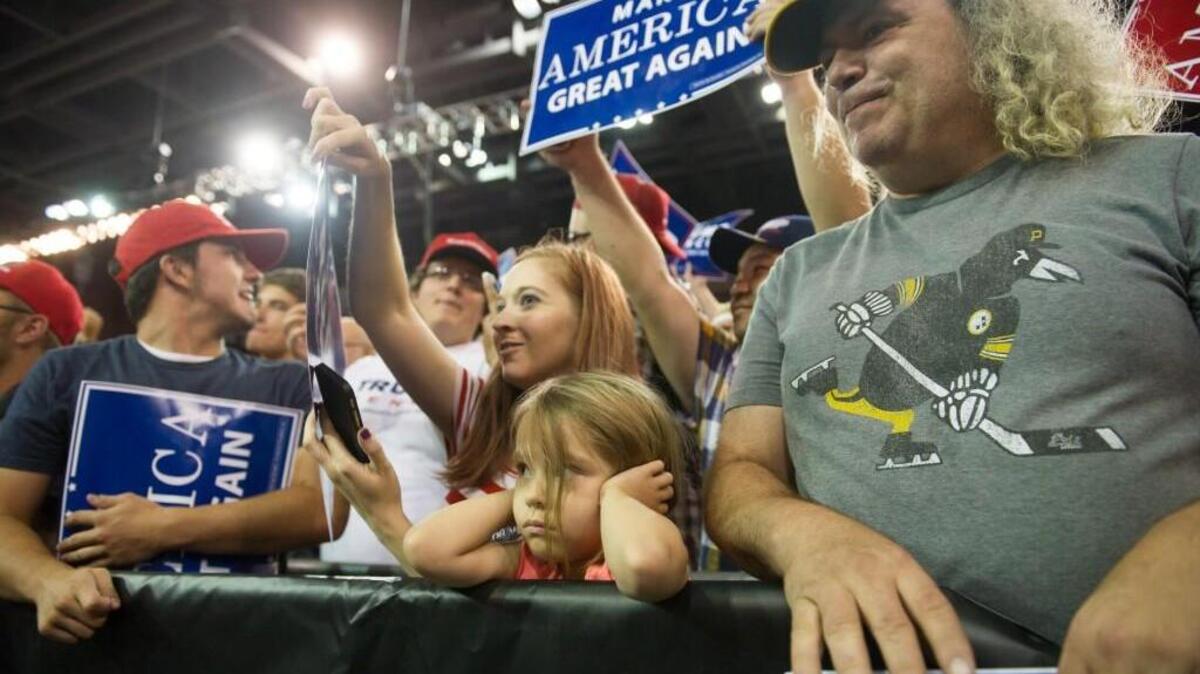 A young attendee responds as Republican candidate for President Donald Trump speaks to supporters at a rally at Erie Insurance Arena in Erie, Pennsylvania.