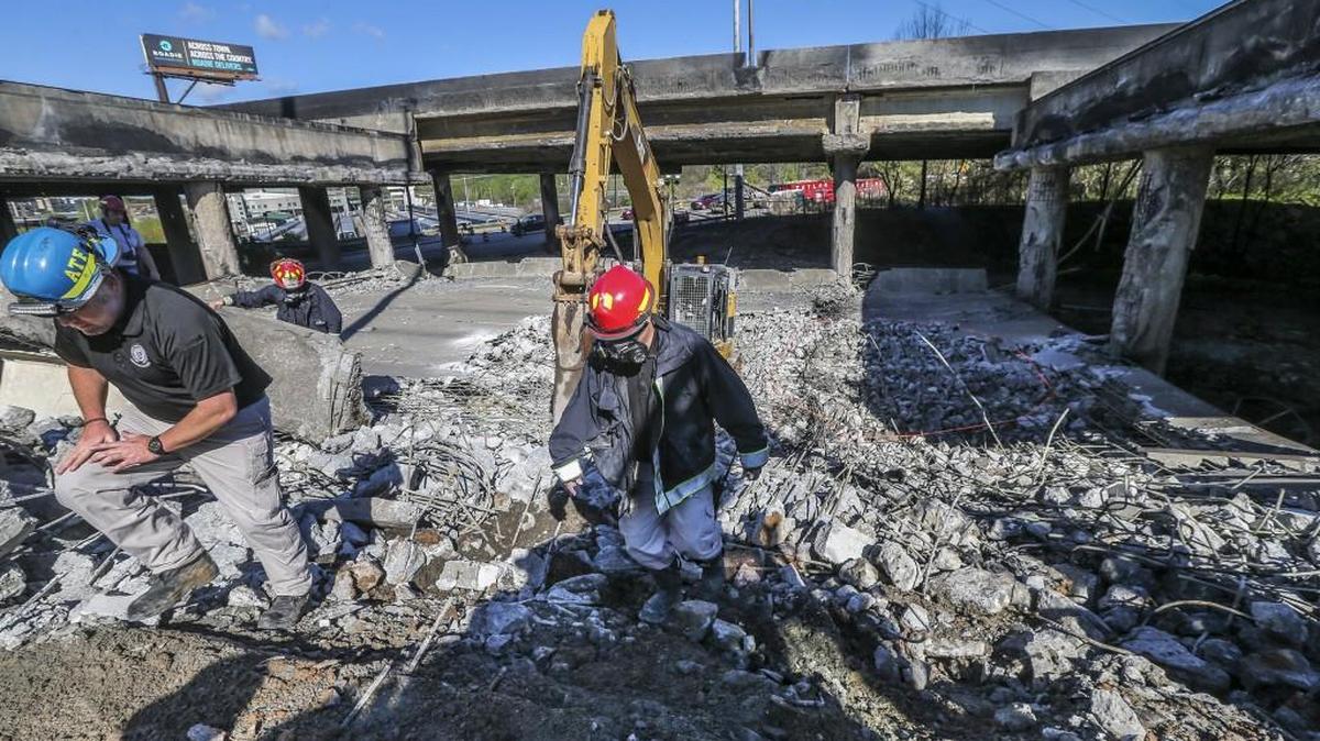 Atlanta firefighters remain on the scene, putting out a smoldering fire March 31 at the I-85 collapse site while construction crews made their way into the zone to begin work in Atlanta, Ga. President Trump and Democrativ leaders agree there is a need for a major program to improve the nation’s infrastructure.