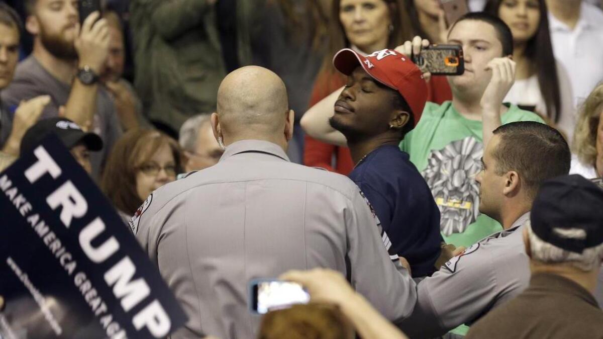 A protester is removed as Donald Trump speaks in Fayetteville.