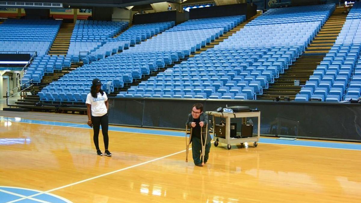 Logan Gin, a wheelchair basketball player, checks out the court at the Smith Center at UNC. A wheelchair basketball tournament is taking place on Sunday at Woollen Gym in Chapel Hill.