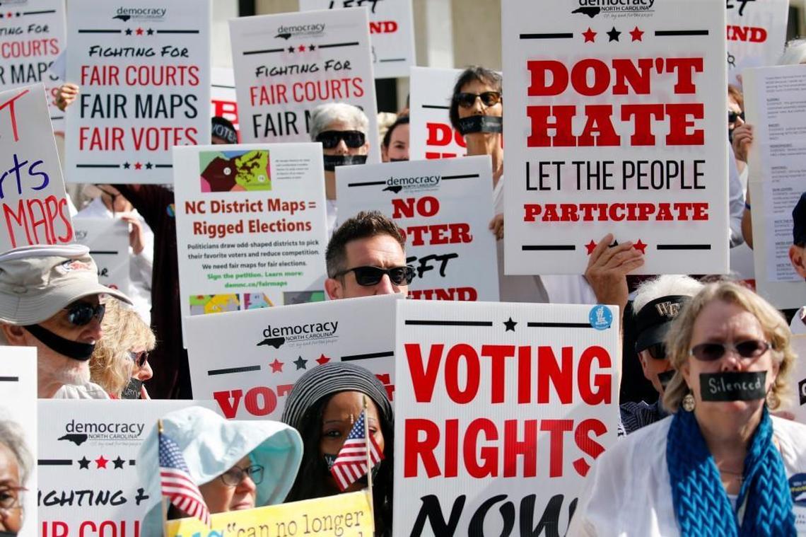In this Oct. 4, 2017 photo about 100 protesters opposed to Republican-drawn redistricting maps march in silence to the Legislative Building in Raleigh to voice their opposition.