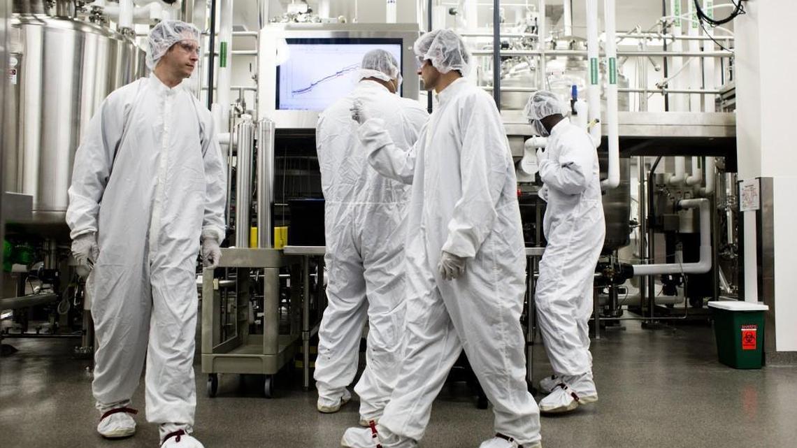 Workers inside a lab used to produce cell cultures at Biogen in Research Triangle Park in Durham in 2014.