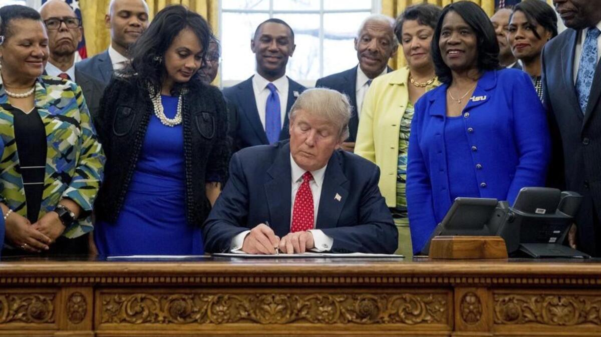 President Donald Trump signs the Historically Black Colleges and Universities HBCU Executive Order, Tuesday, Feb. 28, 2017, in the Oval Office in the White House in Washington.