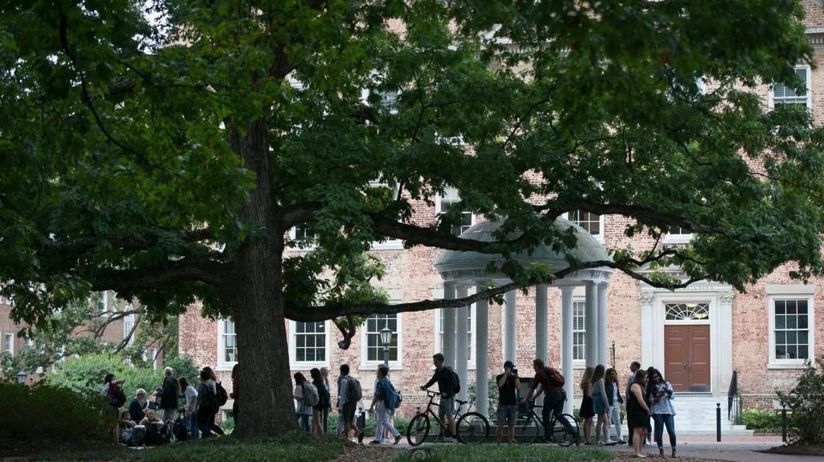 A steady stream of visitors and students visit the Old Well on the University of North Carolina campus on Friday, October 13, 2017 after the NCAA issued their judgement saying they could not conclude academic violations in their case against UNC.