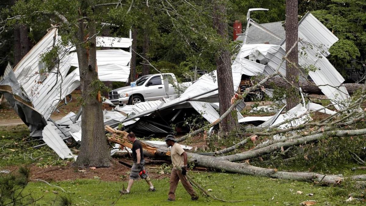 Residents and volunteers clean up Autryville in Sampson County on May 24 after a tornado touched down the day before, damaging the fire station, several trailers and taking down hundreds of trees.