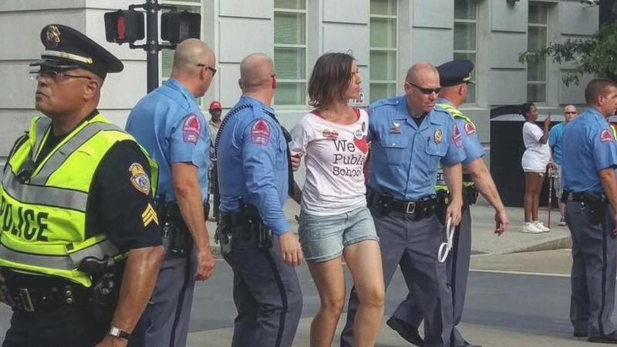Teacher Anca Stefan is arrested for blocking a street in front of the Capitol in Raleigh after marching 23 miles.
