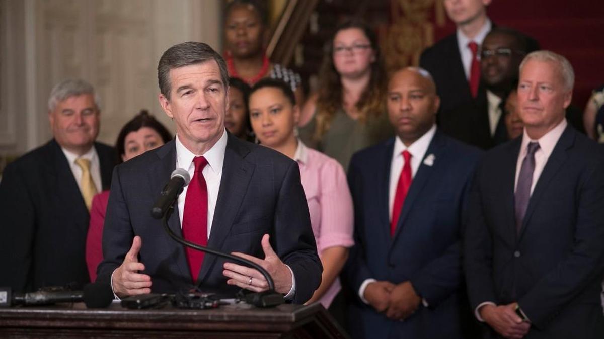 North Carolina Governor Roy Cooper says he will veto the budget bill from the North Carolina legislature during a press conference at the Executive Mansion on Monday, June 26, 2017 in Raleigh, N.C. Flanked by educators, Copper said he is particularly troubled by the budget funding for education.