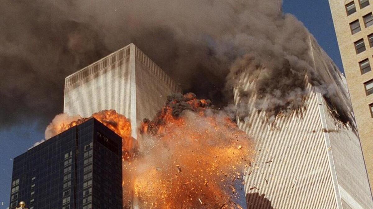 Smoke billows from World Trade Center Tower 1 and flames explode from Tower 2 as it is struck by American Airlines Flight 175 in New York on Sept. 11, 2001.