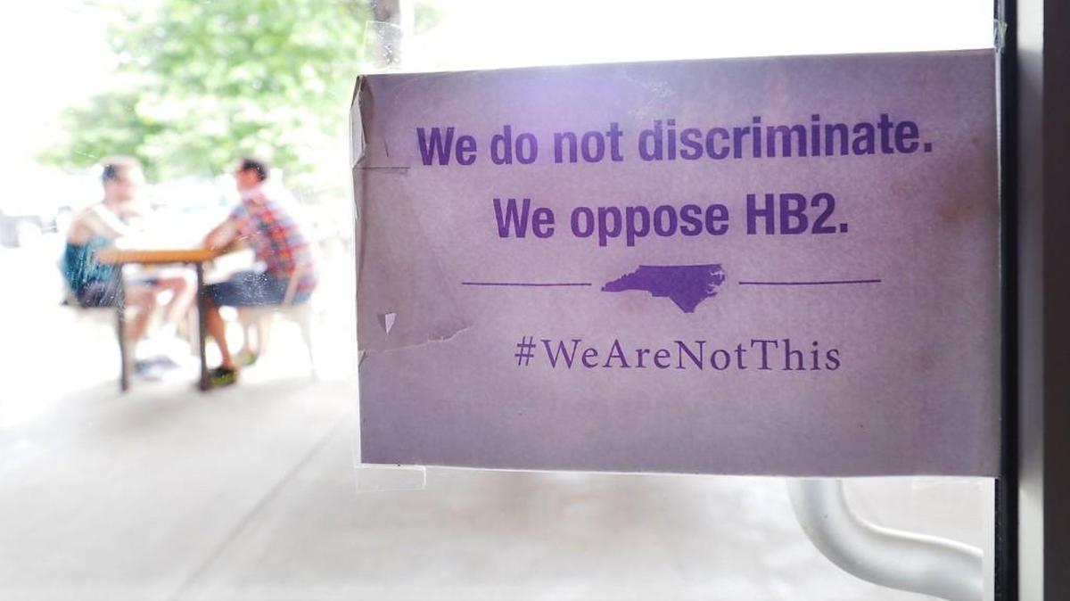 The “We Are Not This” slogan is posted at the entrances to Bull McCabes Irish Pub in Durham.