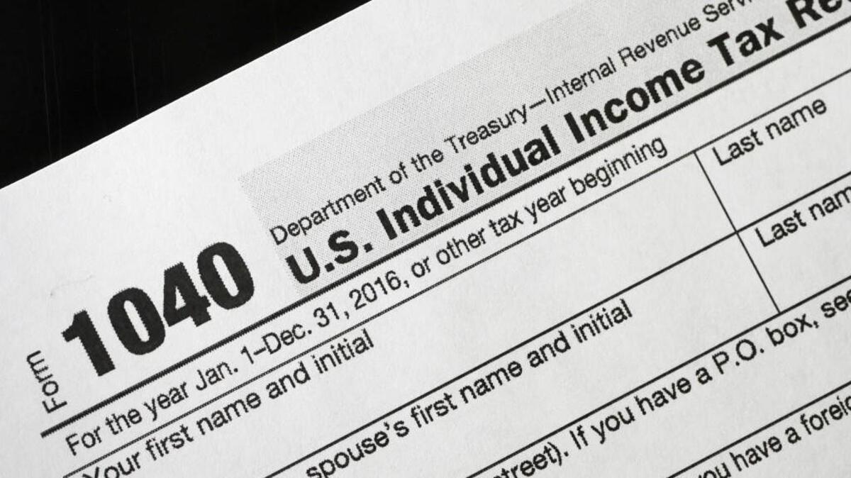 A 1040 tax form appears on display, Tuesday, Jan. 10, 2017, in New York.
