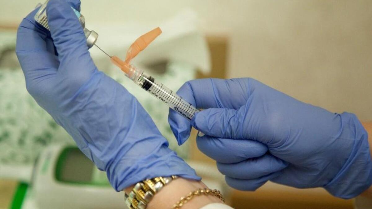 A nurse prepares a flu shot.